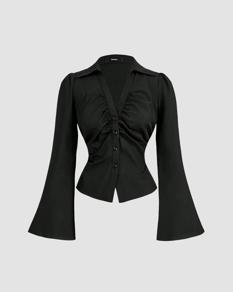 A chic blouse featuring a cinched waist, ruched bust, V-neckline, and a sharp collar, perfect for making a bold statement