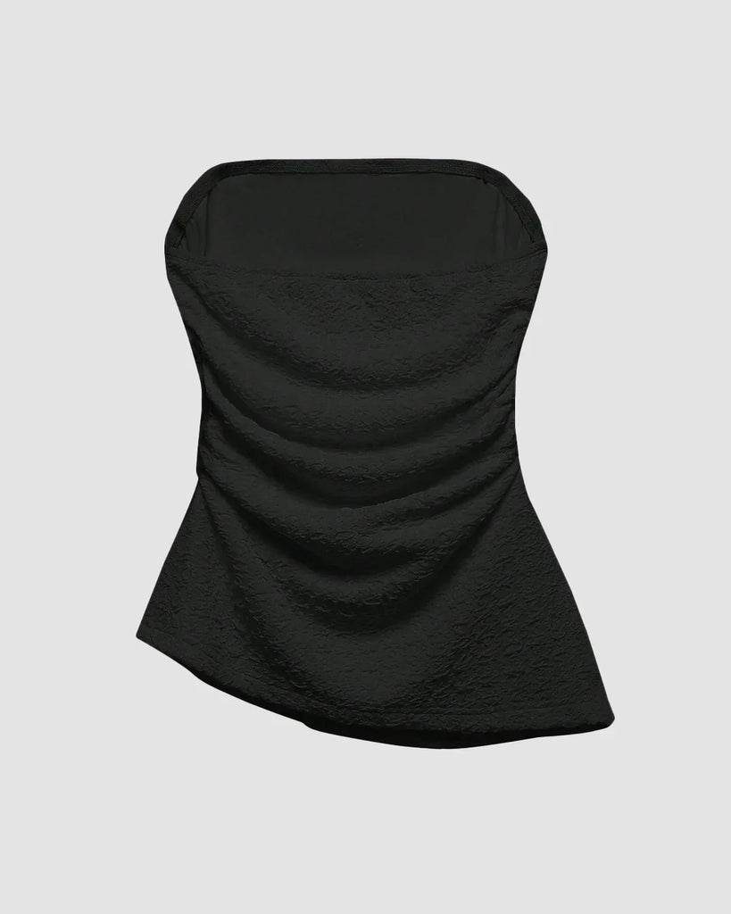 Ruched black tube top with an asymmetric hem, featuring a soft, textured design that flatters and adds a flirty touch on light white background