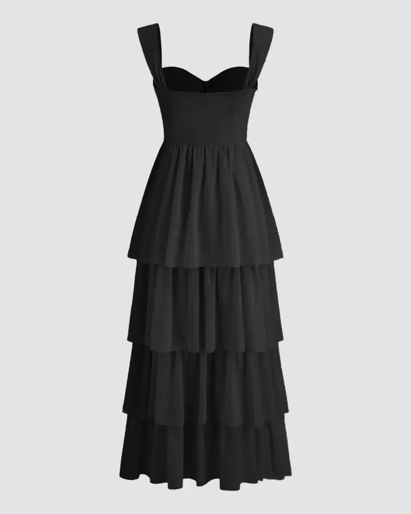 Back view of a Black tiered maxi dress featuring a high slit and sweetheart neckline, elegantly flowing to the floor.