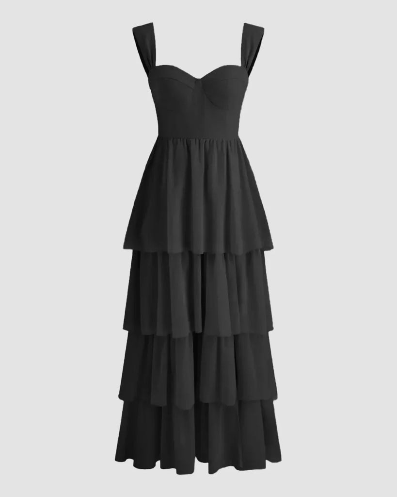 Black tiered maxi dress featuring a high slit and sweetheart neckline, elegantly flowing to the floor.