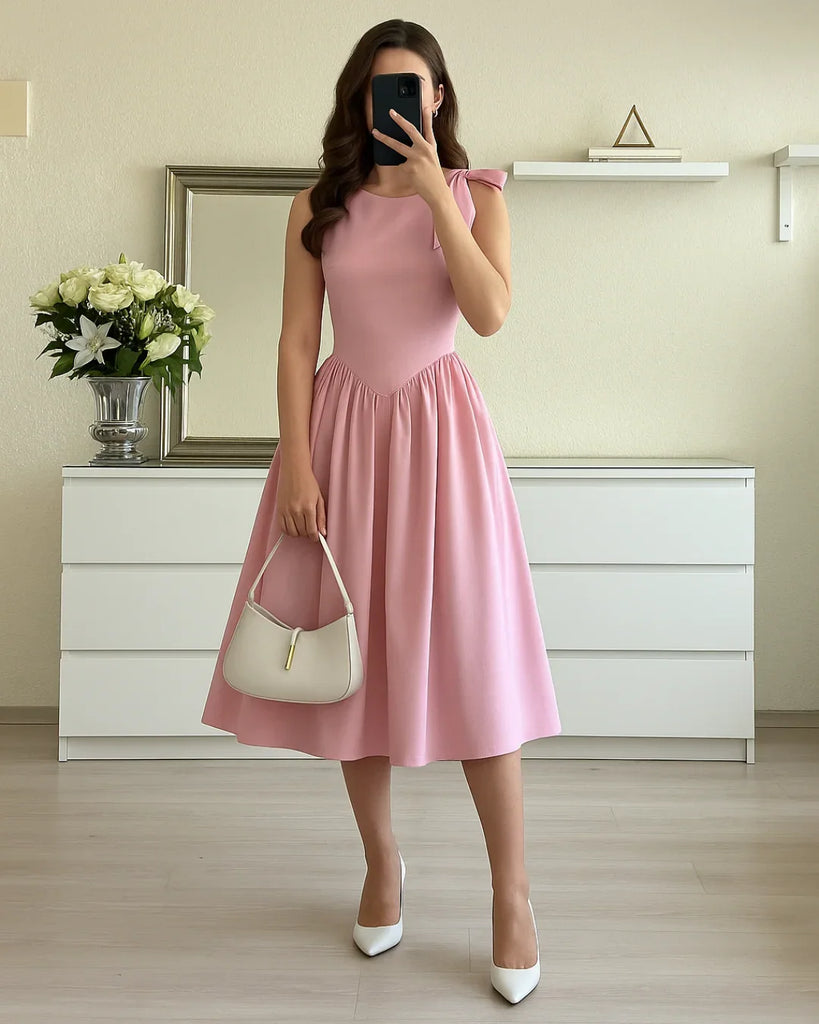 Dark pink midi dress with a boat neck and bow detail at the shoulder, featuring a fit and flare silhouette.