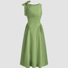 Light pista midi dress with a boat neck and bow detail at the shoulder, featuring a fit and flare silhouette.
