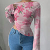 Front view of pink cute top with boat neck and floral print, slim fit with asymmetrical hem and full sleeves