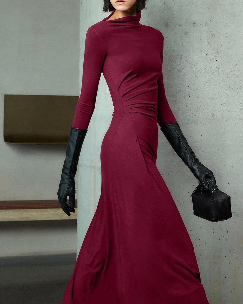 woman in a burgundy long-sleeve dress with an asymmetrical neck and black gloves 