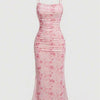 Pink sleeveless floral maxi bodycon dress with a delicate floral print, spaghetti straps, and a draped neckline
