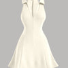 A beige bodycon summer dress featuring a high neck and a low back design.