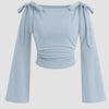 Front view of Bow tie shoulder crop top with soft stretch fabric, long flared sleeves, and a flattering fitted silhouette