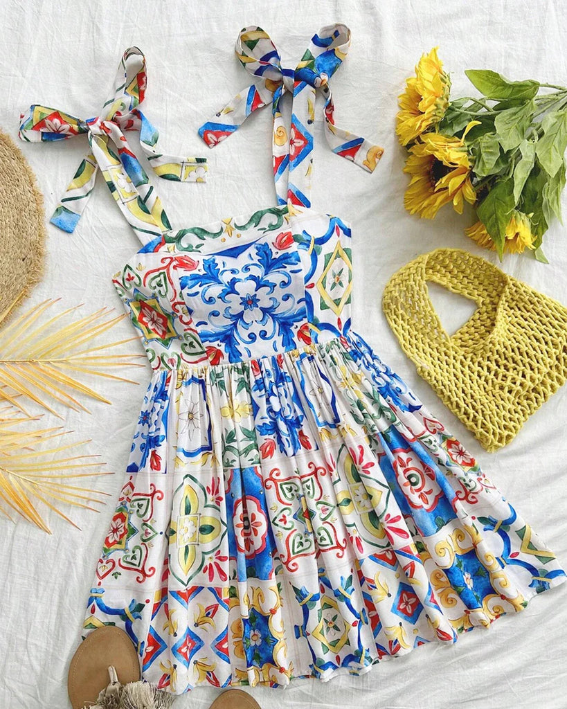 A bright mosaic print A-line mini dress that showcases vibrant colors.