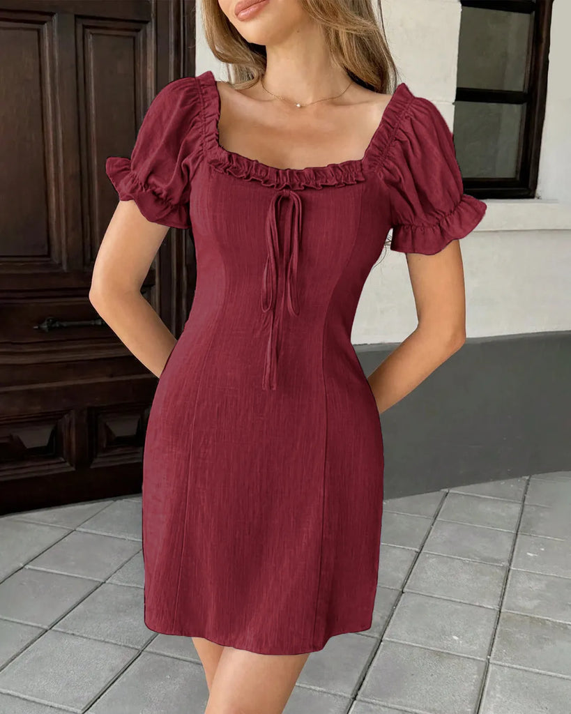 Burgundy mini dress featuring a square neckline, with front tie pleated details, and short puff sleeves