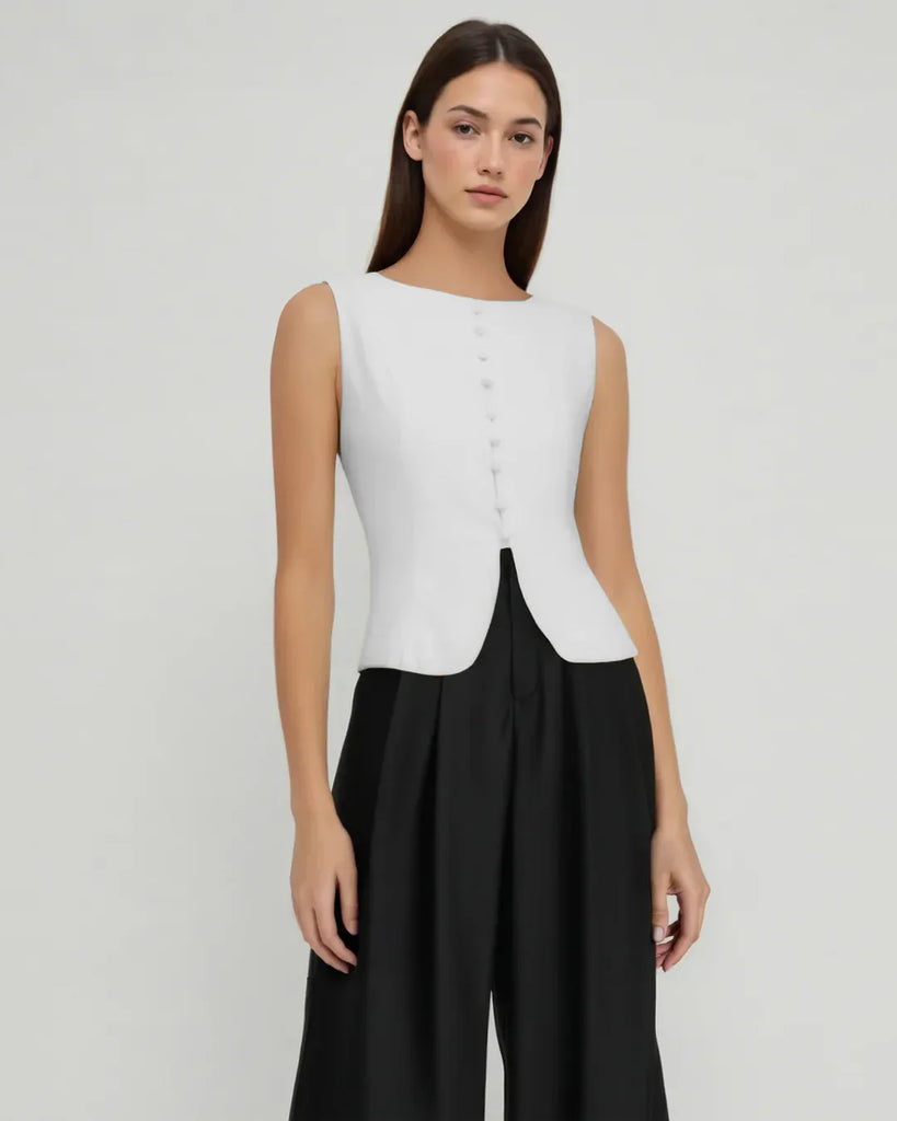 White tailored sleeveless top with a button front design, showcasing a classic and elegant style.