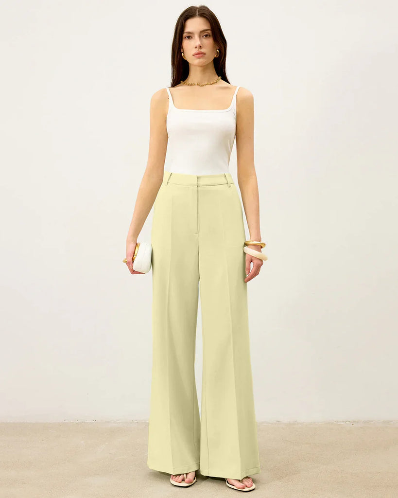 A woman in a checkered asymmetric top and wide-legged trousers, showcasing a stylish co-ord set.