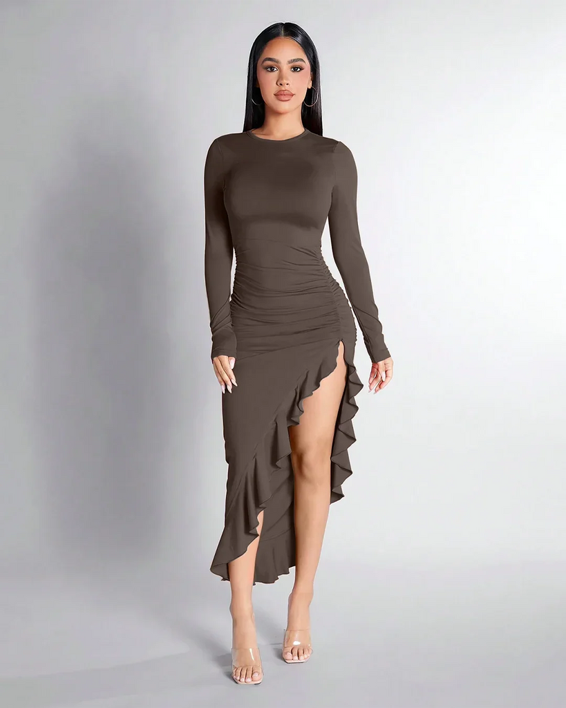 Model in a brown long-sleeve dress with a high slit, showcasing the Coco Ruched High-Slit Ruffle Hem design.
