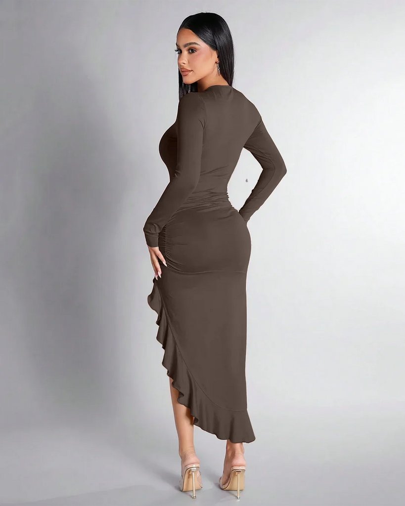 Back view of a Model in a brown long-sleeve dress with a high slit, showcasing the Coco Ruched High-Slit Ruffle Hem design.