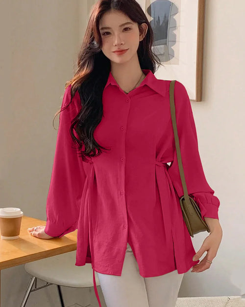 Woman wearing a bright pink shirt of Collared Neck Long Sleeve Structured Flared Top in Pink