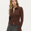 Women wearing Brown long sleeve top with a collared neckline, button front, and split hem detail, designed in a fitted silhouette for a sleek look