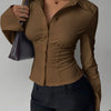 Women wearing brown collared v neck shirt with ruched waist and slim fit silhouette, stylish plain brown shirt.