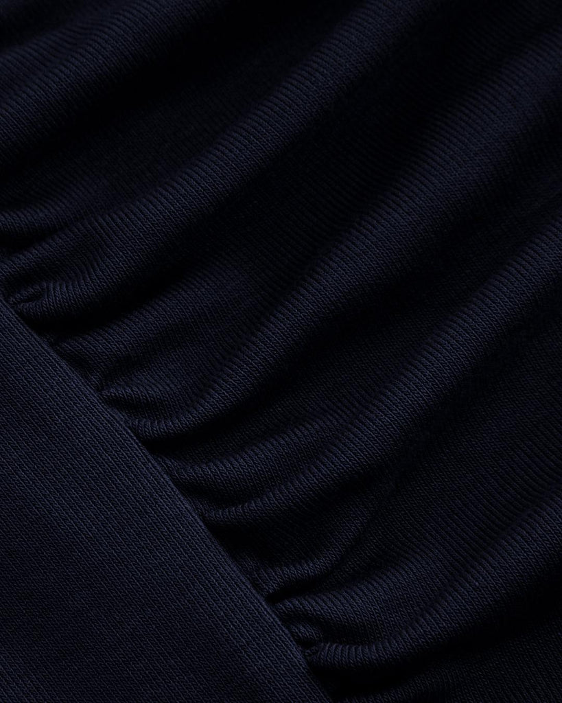 Navy blue ruched mini dress featuring a draped cowl neckline close up view