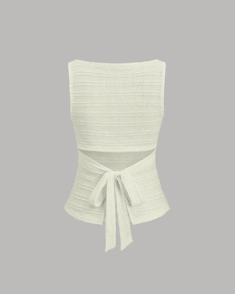 Cream ruched sleeveless tie back top with a stylish detail, perfect for a chic and casual look on a grey background