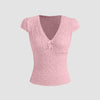 Cute baby pink V-neck tee featuring delicate lace trim and a bow, perfect for adding femininity to casual outfits