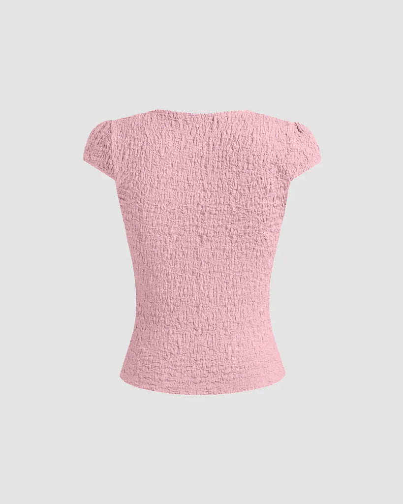 Cute baby pink V-neck tee featuring delicate lace trim and a bow, perfect for adding femininity to casual outfits on a light background