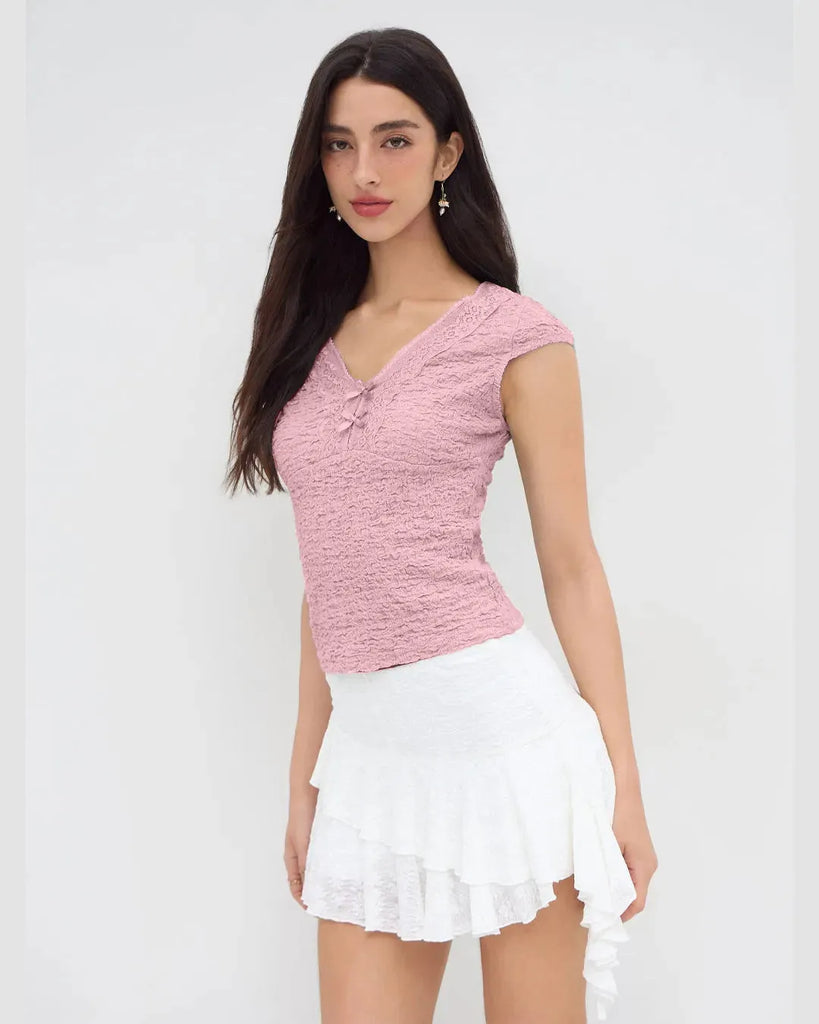 Women wearing Cute baby pink V-neck tee featuring delicate lace trim and a bow, perfect for adding femininity to casual outfits