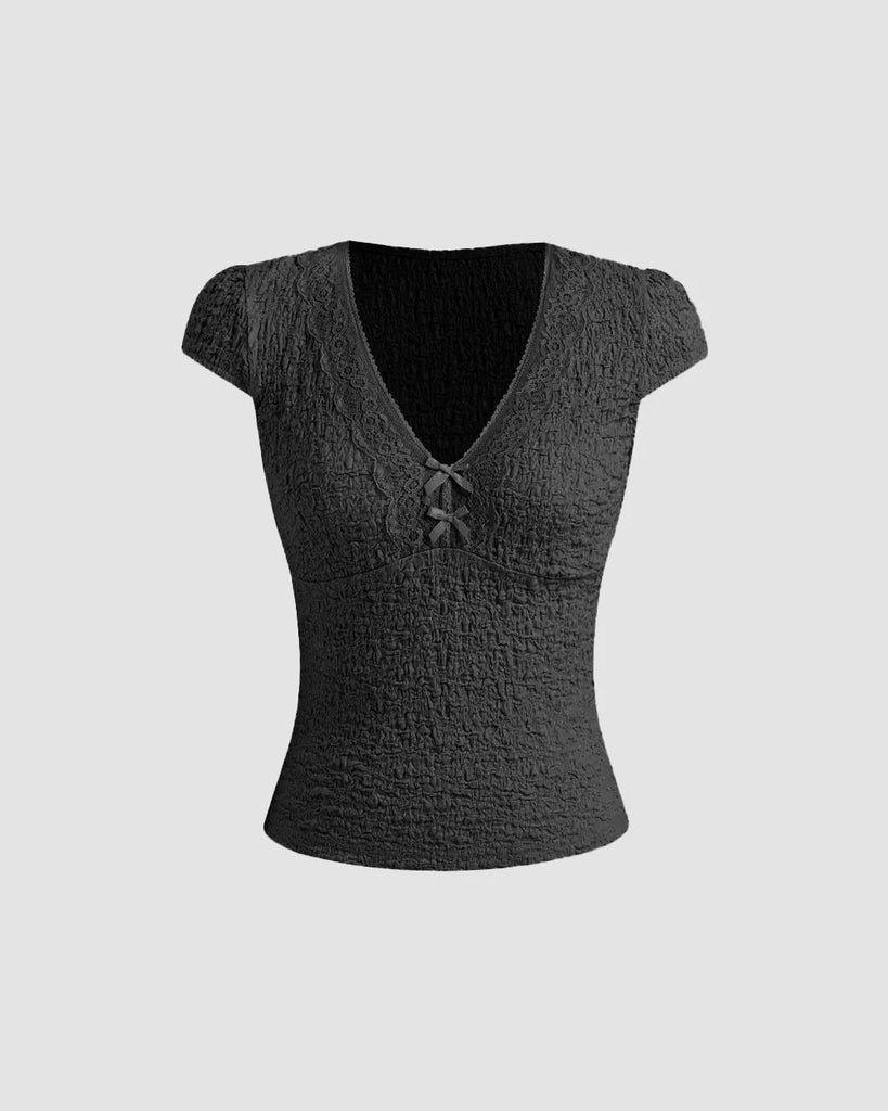 Cute black V-neck tee featuring delicate lace trim and a bow, perfect for adding femininity to casual outfits