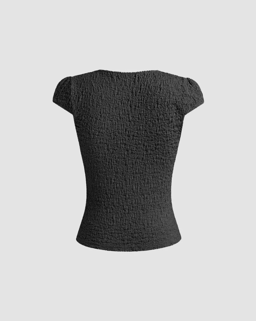 Cute black V-neck tee featuring delicate lace trim and a bow, perfect for adding femininity to casual outfits on a light grey background