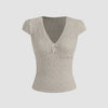 Cute light grey V-neck tee featuring delicate lace trim and a bow, perfect for adding femininity to casual outfits