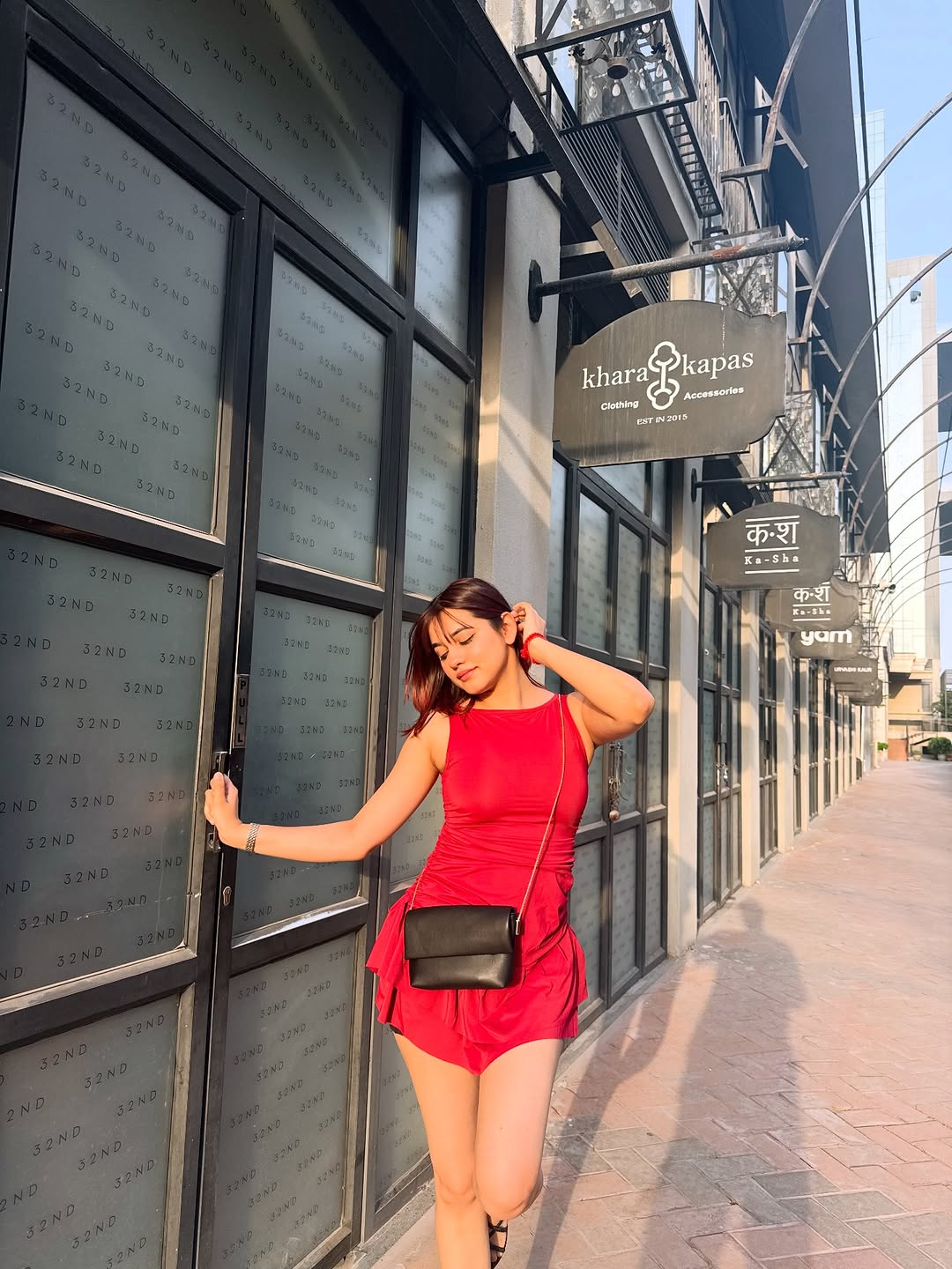 Customer photo 3 of Sleeveless Mini Dress with Ruched Waist and Flare Hem in Burgundy