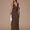 Front view of Brown sleeveless maxi dress with deep V-neck and backless tie detail, featuring a sleek fitted silhouette
