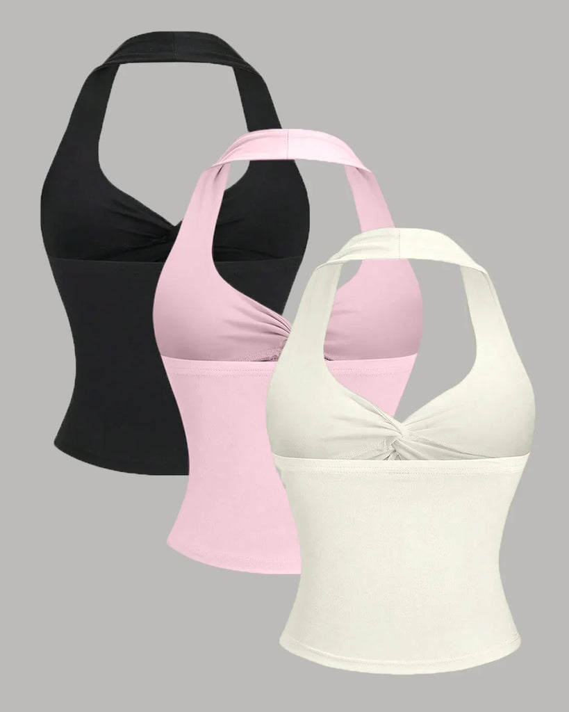 Back view of a women's tops in various colors, including a draped cowl neck sleeveless top in baby pink.