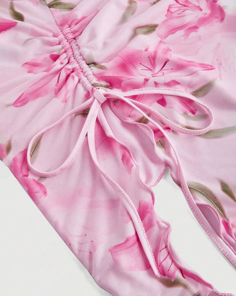 Close up of dusty pink floral asymmetrical dress with a ruched tube top design, perfect for a stylish summer look
