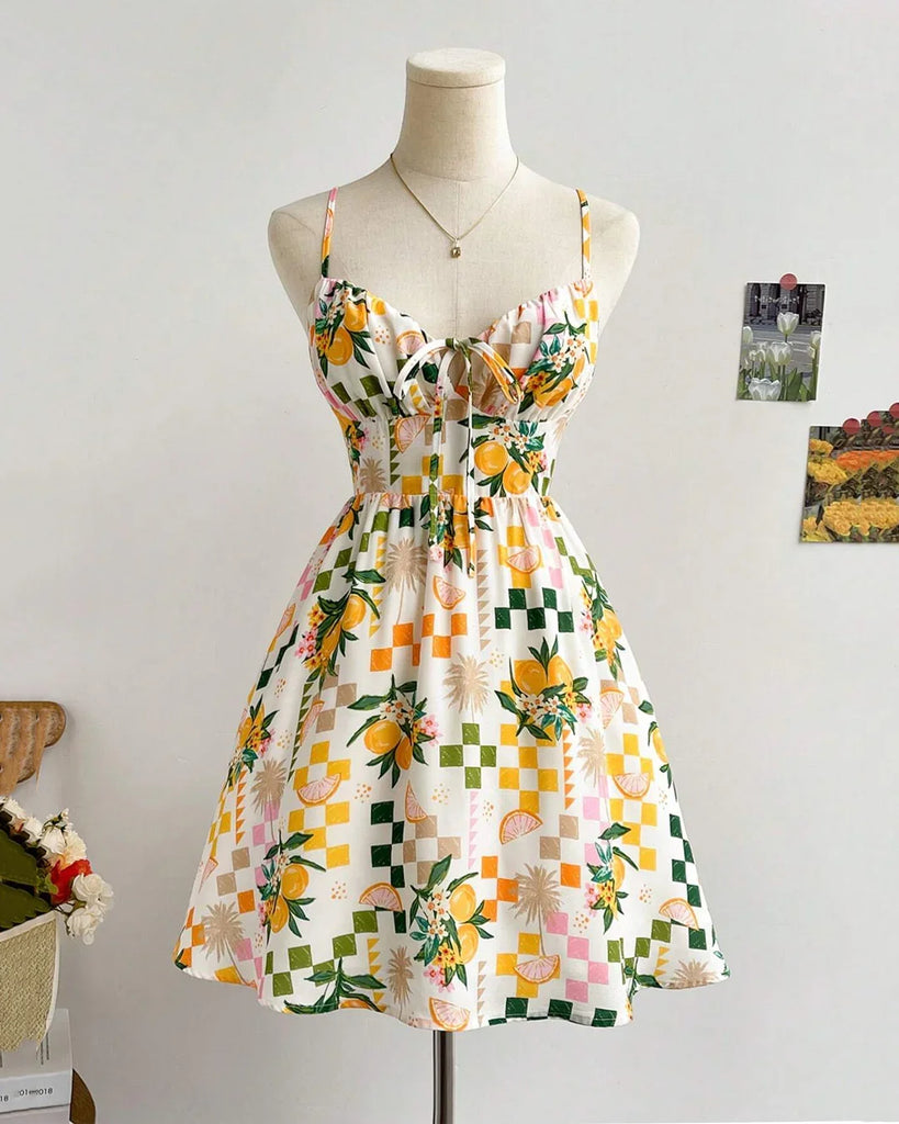 Floral Pixel Print Smocked Mini Dress featuring a vibrant pattern of yellow and green flowers on a light background.
