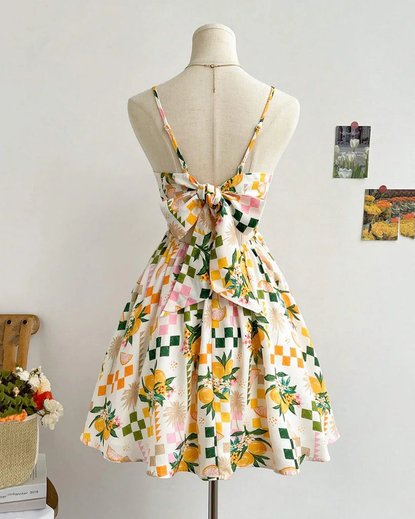 Floral Pixel Print Smocked Mini Dress featuring a vibrant pattern of yellow and green flowers on a light background.
