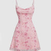 Pink floral spaghetti strap mini dress with draped neckline, fitted bodice, and sheer layered hem, shown front and back.