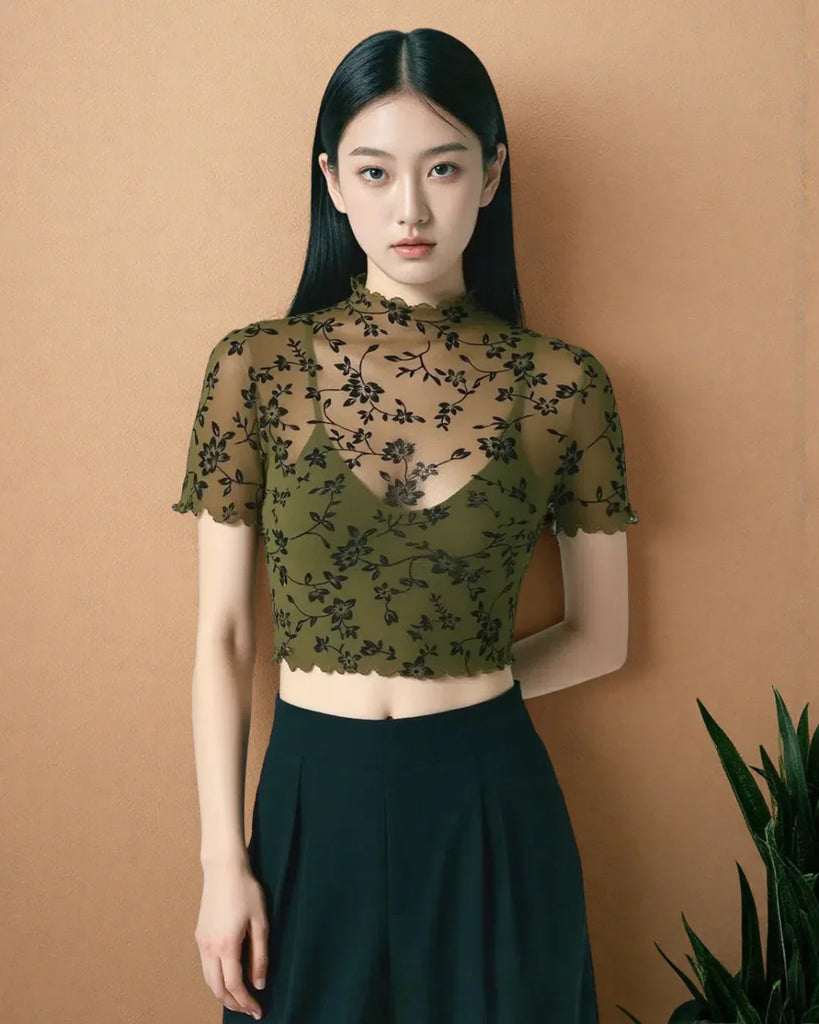 Sheer mesh top with a floral print, mock neckline, and delicate lettuce trim, offering a lightweight and airy feel with a touch of elegance.