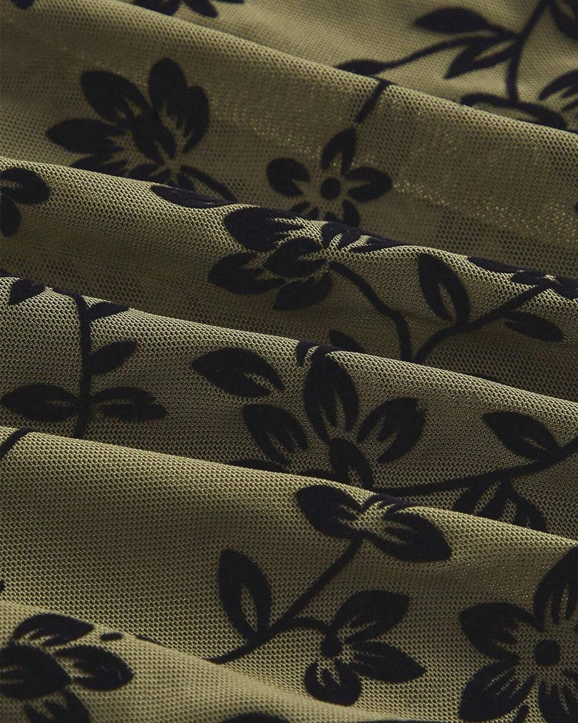 Close up of sheer mesh top with a floral print, mock neckline, and delicate lettuce trim, offering a lightweight and airy feel with a touch of elegance.