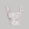 floral print sleeveless tank top featuring a white background adorned with pink flowers