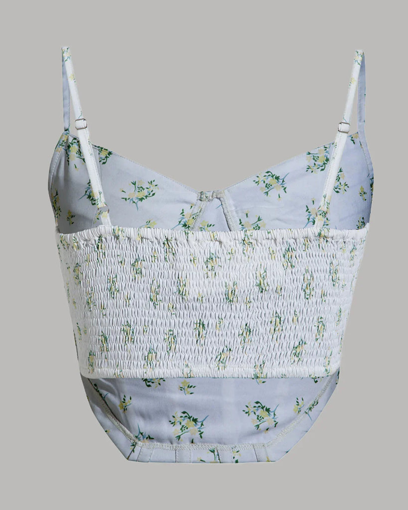 Back view of a White floral print corset top with spaghetti straps displayed against a neutral background.