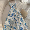 Front view of Blue and white floral square neck maxi dress with sleeveless design, flowy silhouette and full-length hem
