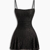 Front view of black floral bodycon dress with spaghetti straps, textured fabric and flared mini silhouette for a sleek look.