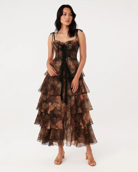 Front view of a woman in Floral tiered corset gown with sheer ruffles and a detachable skirt, featuring a vibrant flower pattern