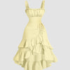 Yellow high-low midi dress with ruffles, featuring a ruched square neck and ruffle hem, styled in French Vanilla.
