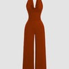 Halter cowl neck wide leg jumpsuit in brick brown fabric, showcasing a stylish and elegant design.