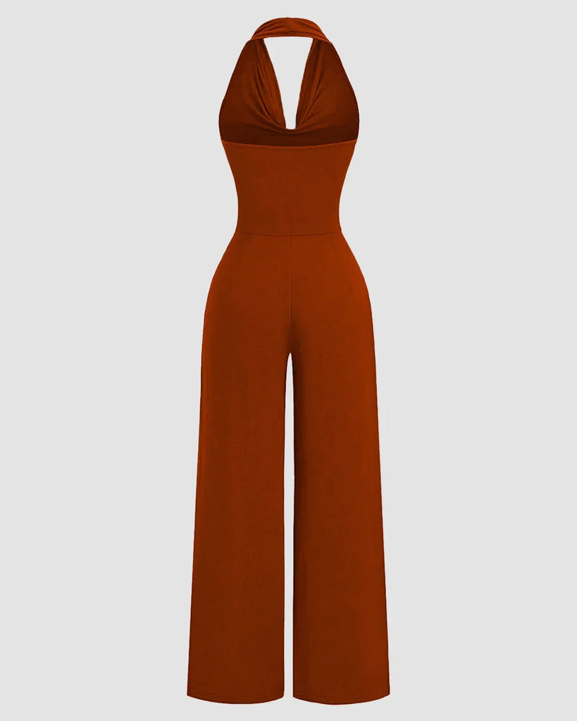 Back view of a Halter cowl neck wide leg jumpsuit in brick brown fabric, showcasing a stylish and elegant design.
