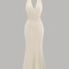 Front view of beige halter neck bodycon maxi dress with ruched waist and flared hem, elegant halter neck bodycon dress.