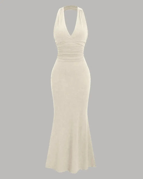 Front view of beige halter neck bodycon maxi dress with ruched waist and flared hem, elegant halter neck bodycon dress.