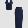 Front view of navy blue halter neck backless top paired with slit side skirt, sleek blue skirt and top co ord set.