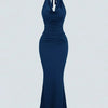 Front view of Navy blue halter neck bodycon maxi dress with ruched waist, sleeveless design, and flared hem for elegant party wear.