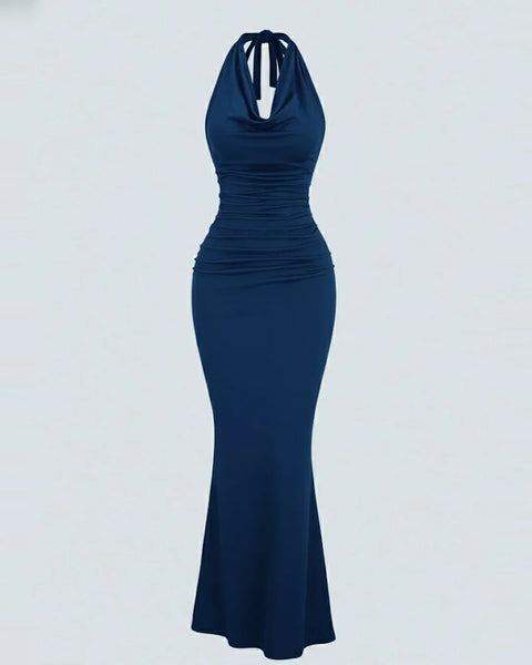 Front view of Navy blue halter neck bodycon maxi dress with ruched waist, sleeveless design, and flared hem for elegant party wear.
